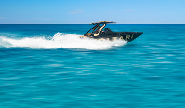 the VOLTARI 260 in Ballistic Charcoal and Gold speeding through blue waters in Bimini, Bahamas