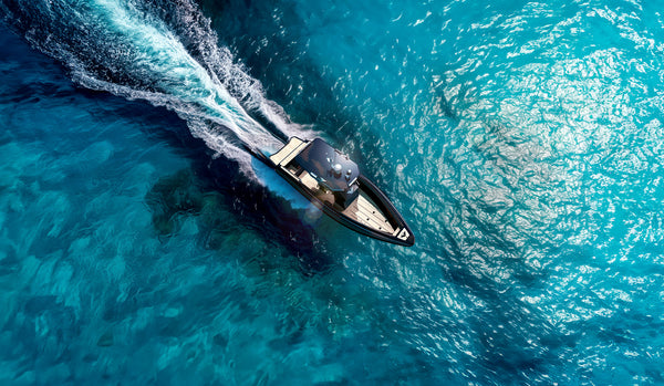 Aerial image of the VOLTARI Poseidon in Ballistic Charcoal running through clear blue ocean waters